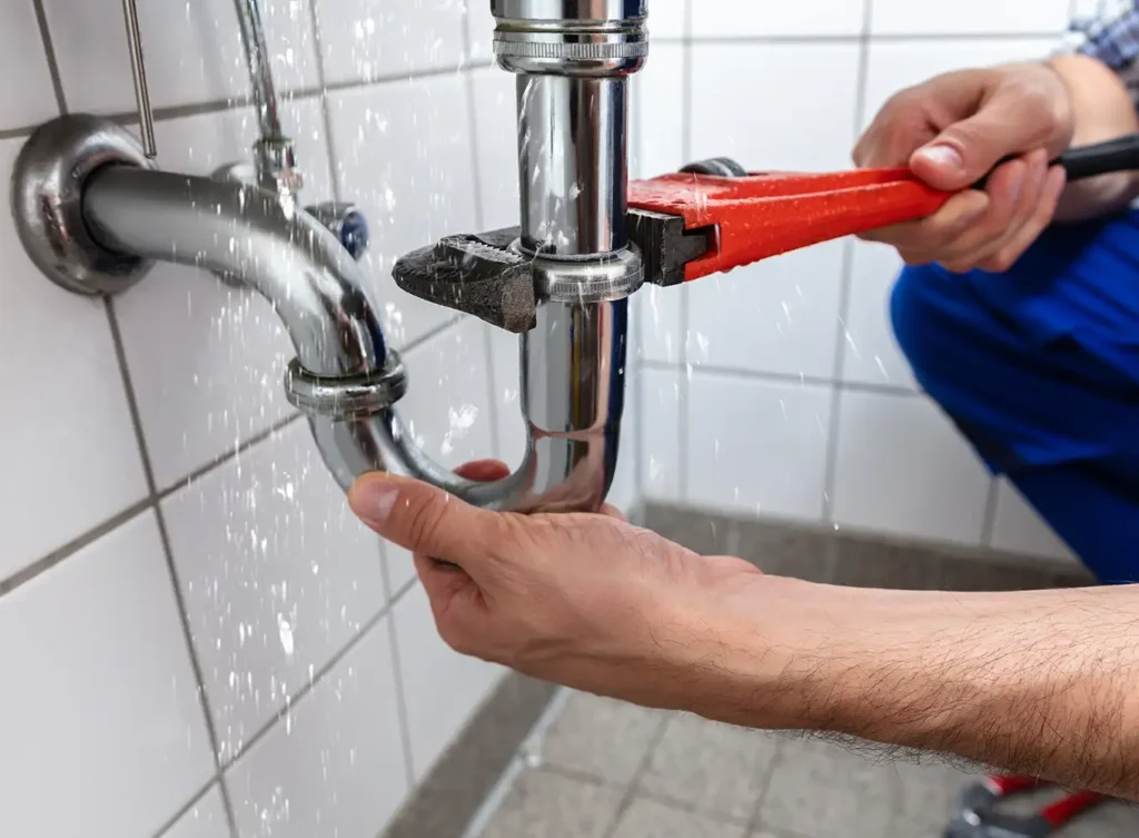 plumber repairing a leaking pipe alton illinois